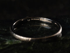 thumbnail of De Beers Talisman Blacked Gold Diamond Band (detail of inside showing stamp that reads "DE BEERS DE 750 B53709)