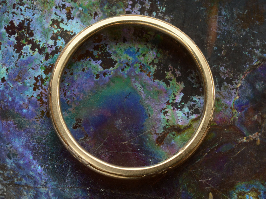 Side profile of c1930 Patterned 14K Yellow Gold Wedding Band (on colorful background)