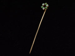thumbnail of An antique yellow gold Victorian stick pin with three opals and three vivid green demantoid garnets arranged in a circle. Shown on black background.