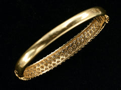 thumbnail of Underside of vintage 18K yellow gold bracelet set with three rows of round white diamonds in a fish-scale like pattern, shown on dark background.