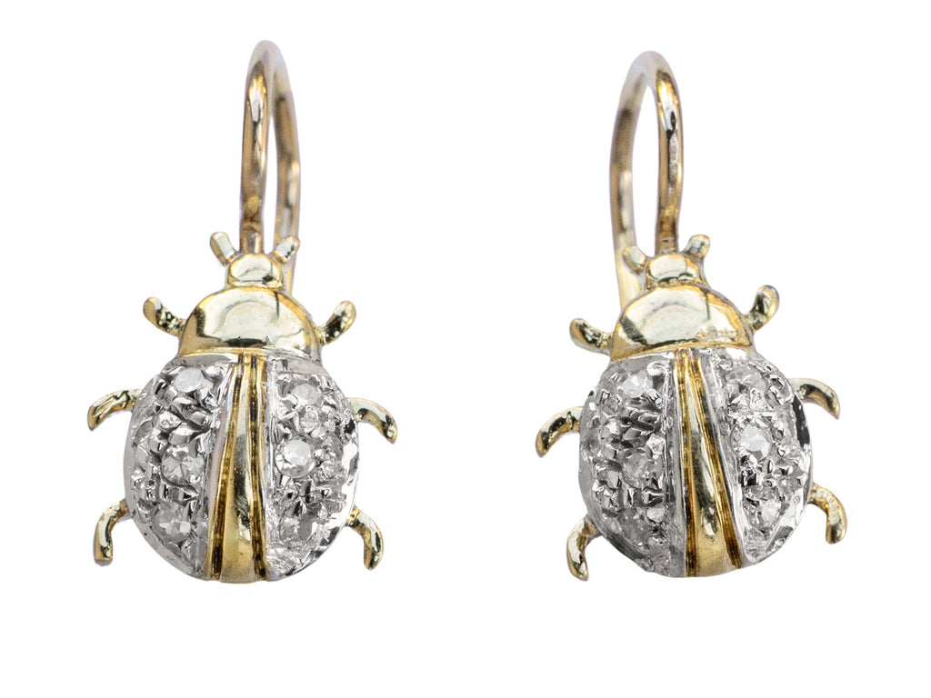 A pair of vintage bug-shaped earrings in yellow gold with white gold details and single cut diamonds set in the bodies. On white background.