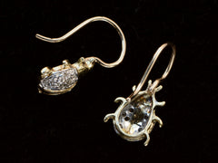 thumbnail of Side and reverse side detail views of a pair of vintage bug-shaped earrings in yellow gold with white gold details and single cut diamonds set in the bodies. On black background.