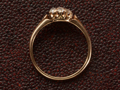 thumbnail of Side profile of an antique rose gold Victorian ring with seven old European cut diamonds set in a cluster. Shown on dark textured background.