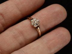 thumbnail of An antique rose gold Victorian ring with seven old European cut diamonds set in a cluster. Shown on finger