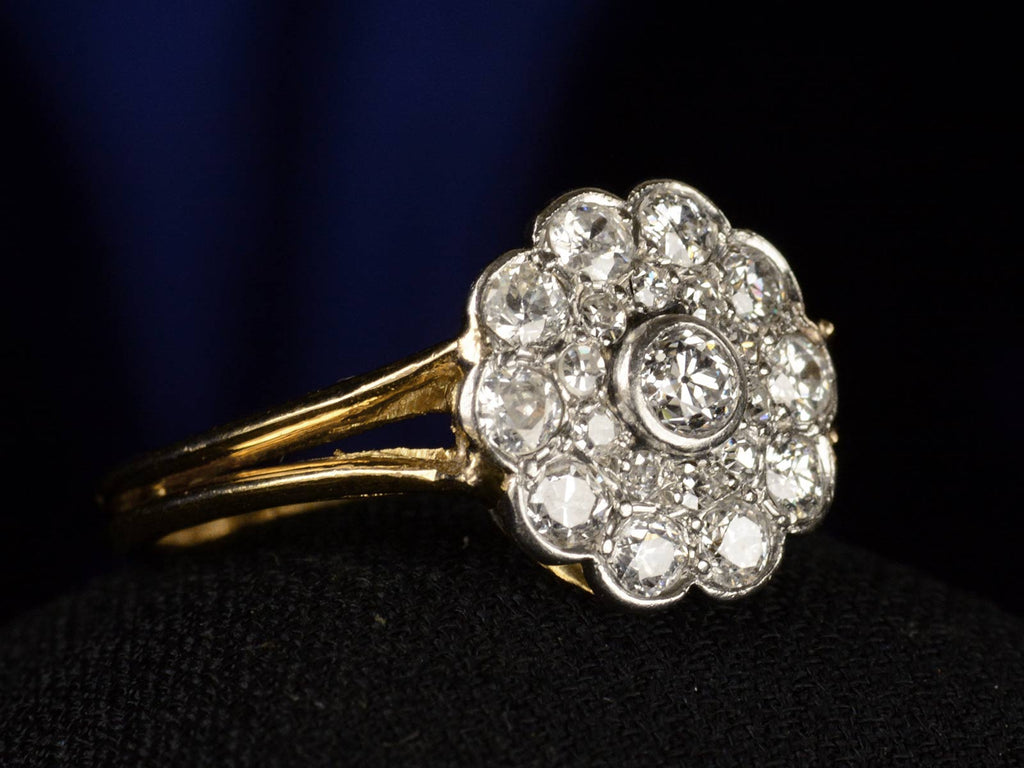 Left angle view of c1920 Diamond Cluster Ring, 18K Yellow Gold and Platinum (shown on black background)