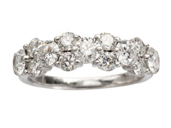thumbnail of Band like platinum ring, half encrusted with a cluster of round diamonds, shown on white background. 