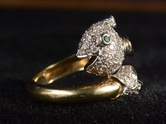 thumbnail of Detail angled view of emerald-eyed diamond studded fish ring in platinum and yellow gold, shown on dark  background.