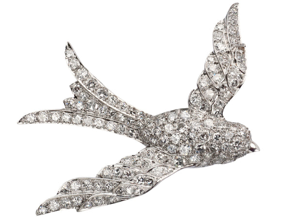 Vintage c1950 diamond-studded bird-shaped brooch on a white background