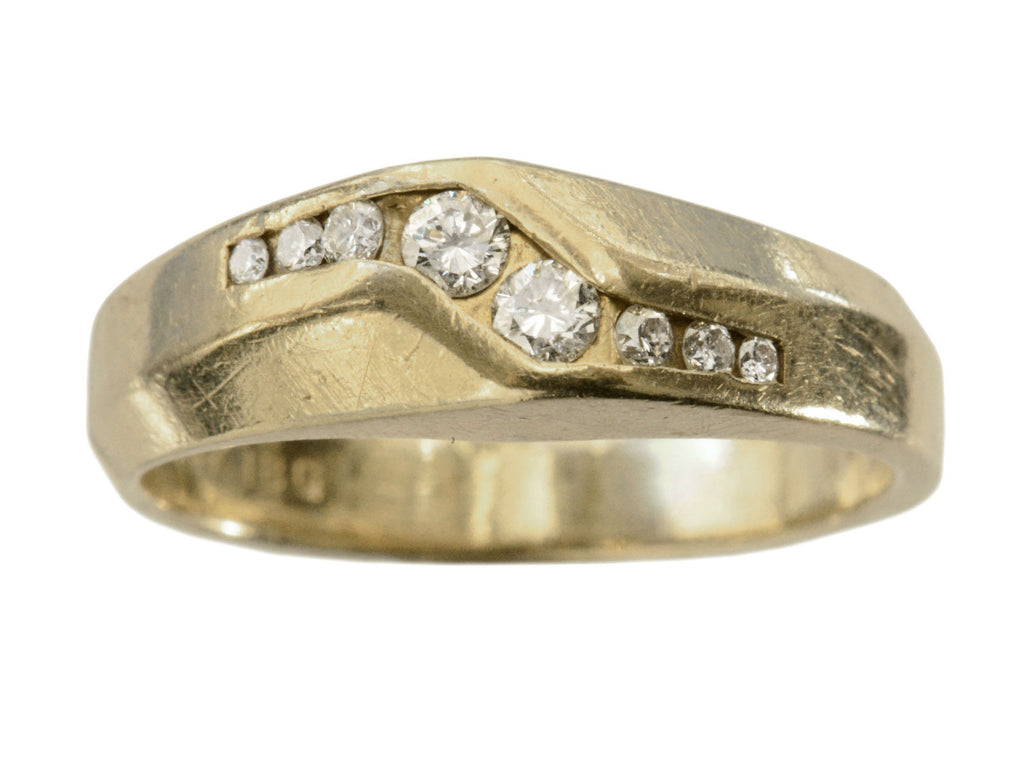 A c1980 ring with a zig-zag of diamonds set in 14K yellow gold, shown on white background.