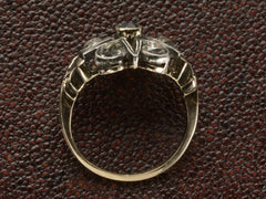 thumbnail of Side profile of an antique silver-topped rose gold Victorian ring with a star design centering on a blue sapphire and old mine cut diamonds set in between each point. Shown on dark textured background.