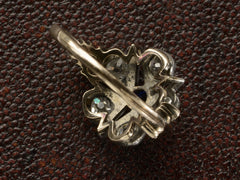 thumbnail of Inside view of an antique silver-topped rose gold Victorian ring with a star design centering on a blue sapphire and old mine cut diamonds set in between each point. Shown on dark textured background.