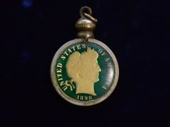 thumbnail of Pendant with gilt and green enamel dime mounted in brass, shown on white background. The words "United States of America 1898" are visible on the dime. Shown on dark background.