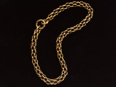thumbnail of A double-link chain necklace with reeded texture, shown laid out in elliptical shape on dark background.