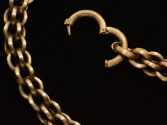 thumbnail of Detail view of a double-link chain necklace with reeded texture, showing the clasp open. On dark background.