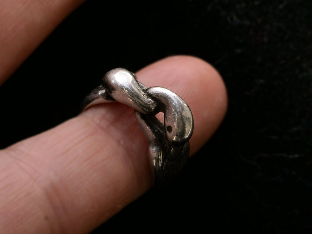 Sterling silver double swan head ring, on finger.