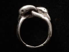 thumbnail of Side profile of sterling silver double swan head ring, on black background.