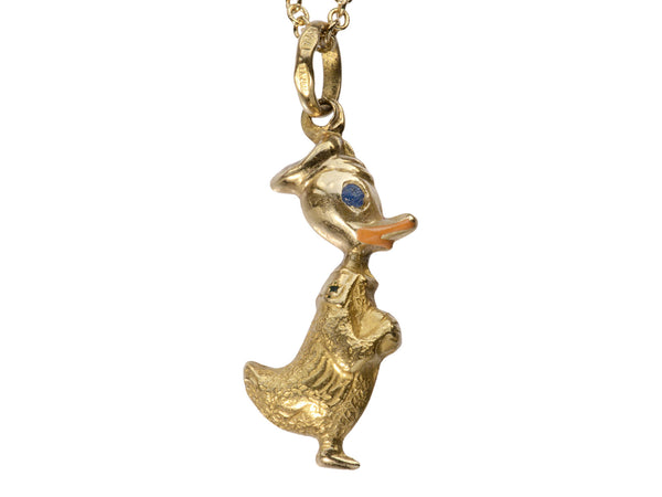 Detail of gold Donald Duck pendant with orange and blue enamel details, on white background. Stamps on bale read "907 VI 750"