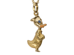 thumbnail of Detail of gold Donald Duck pendant with orange and blue enamel details, on white background. Stamps on bale read "907 VI 750"