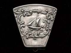 thumbnail of An antique silver wedge-shaped c1920 Dutch pillbox with the image of a sailboat, shown on black background.