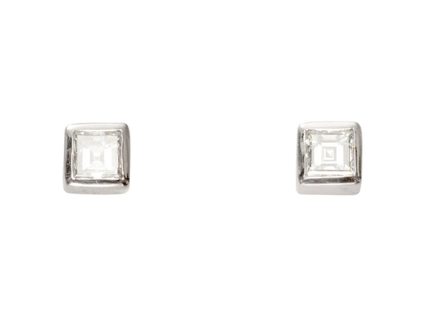 Pair of 0.19cttw square step cut white diamond stud earrings in platinum bezels, shown on white background.