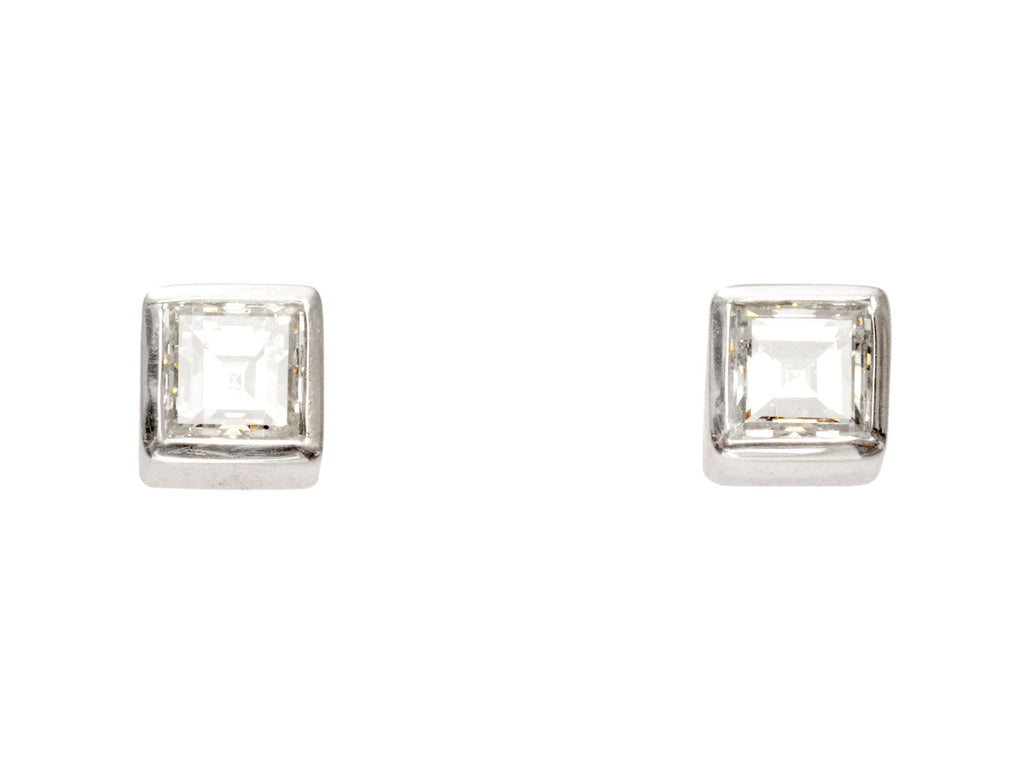 A pair of 0.35cttw Square Step Cut White Diamonds in Platinum Bezels, Shown on white background.