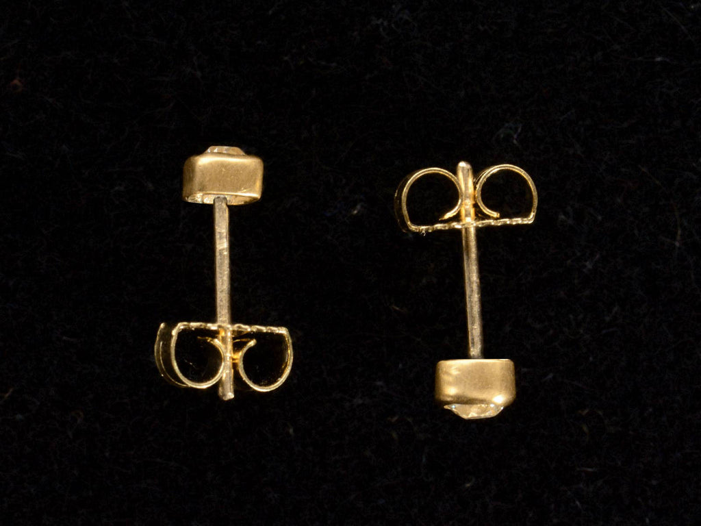 Side Profiles of EB Stud Earrings with Old Mine Cut Diamonds Set in 22K Yellow Gold Bezels (shown on black background)