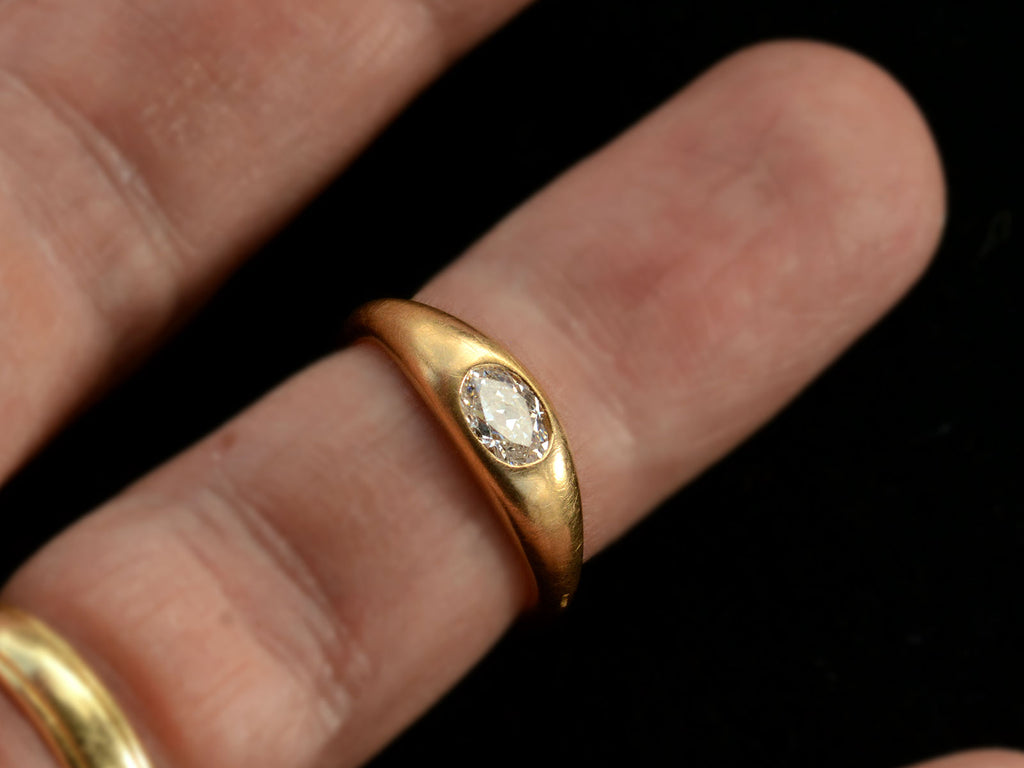 EB Modern engagement ring with a 0.49ct moval diamond flush set in 22K yellow gold (shown on finger)