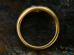 thumbnail of Side profile of EB Modern engagement ring with a 0.49ct moval diamond flush set in 22K yellow gold (shown on dark background)