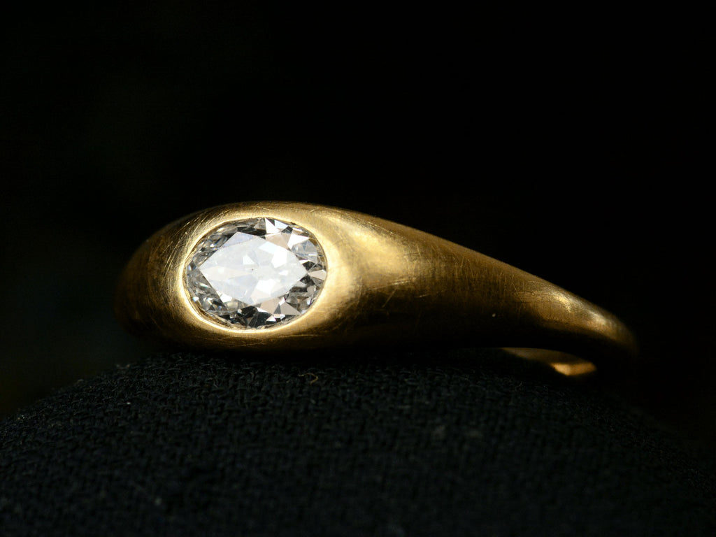 Right angled view of EB Modern engagement ring with a 0.49ct moval diamond flush set in 22K yellow gold (shown on dark background)