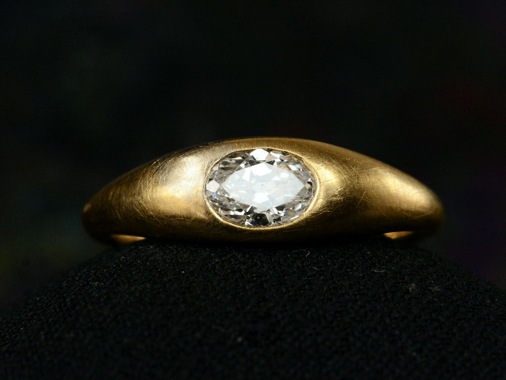 Front profile view of EB Modern engagement ring with a 0.49ct moval diamond flush set in 22K yellow gold (shown on dark background)