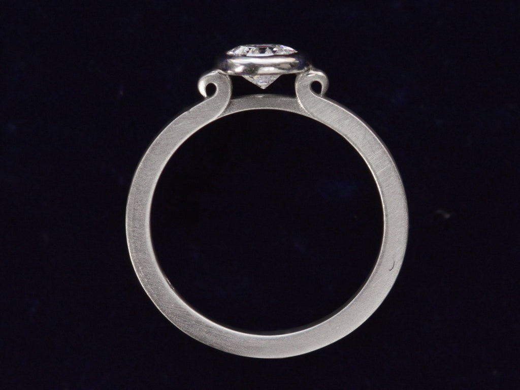 EB Round Step Cut Platinum Ring (profile view on dark blue background)