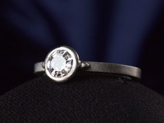 thumbnail of EB Round Step Cut Platinum Ring (right side angle view on dark background)