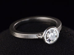 thumbnail of EB Round Step Cut Platinum Ring (left side angle view on dark background)