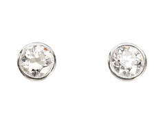 thumbnail of A pair of EB Modern stud earrings with platinum bezels and round white old cut diamonds. Shown on white background.
