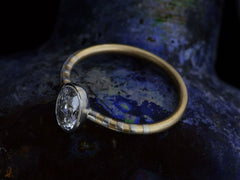 thumbnail of Elevated angled view of EB 0.69ct Oval Diamond Ring with Platinum Bezel and Striped Gold and Platinum Band (shown on dark background)