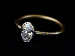 thumbnail of Right angled view of EB 0.69ct Oval Diamond Ring with Platinum Bezel and Striped Gold and Platinum Band (shown on dark background)