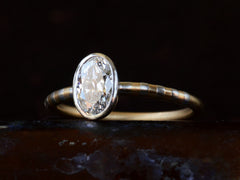 thumbnail of Angled view of EB 0.69ct Oval Diamond Ring with Platinum Bezel and Striped Gold and Platinum Band (shown on dark background)