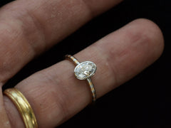 thumbnail of EB 0.69ct Oval Diamond Ring with Platinum Bezel and Striped Gold and Platinum Band (shown on finger for scale)