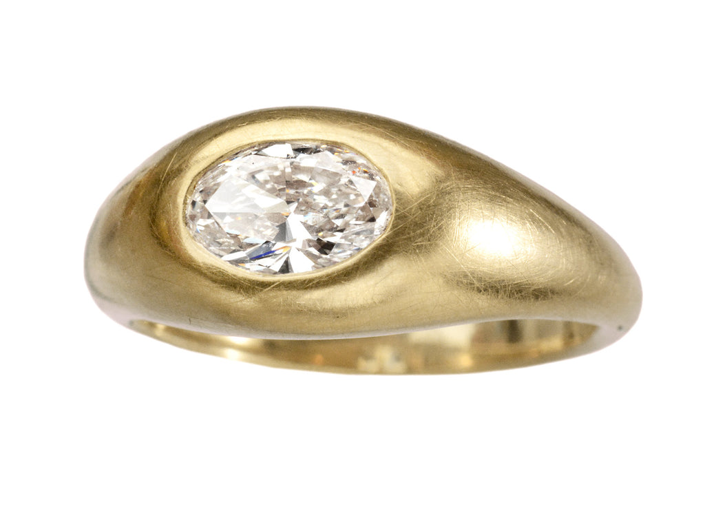 Right angled front view of EB Modern flush set oval white diamond in rounded 22K yellow gold setting, shown on white background.