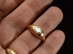 thumbnail of EB Modern flush set oval white diamond in rounded 22K yellow gold setting, shown on finger.