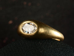thumbnail of Right angled front view of EB Modern flush set oval white diamond in rounded 22K yellow gold setting, shown on dark background.