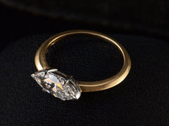 thumbnail of Elevated, angled view of EB Modern engagement ring solitaire with marquise diamond set in platinum prongs with an 18K yellow gold knife edge shank, shown on dark background.