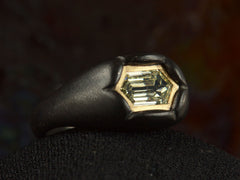 thumbnail of Left front angle view of EB Modern hexagonal light yellow diamond set in yellow gold bezel sunken into pillowy blackened silver mounting (shown on dark background)