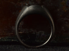 thumbnail of Side profile view of EB Modern hexagonal light yellow diamond set in yellow gold bezel sunken into pillowy blackened silver mounting (shown on dark background)