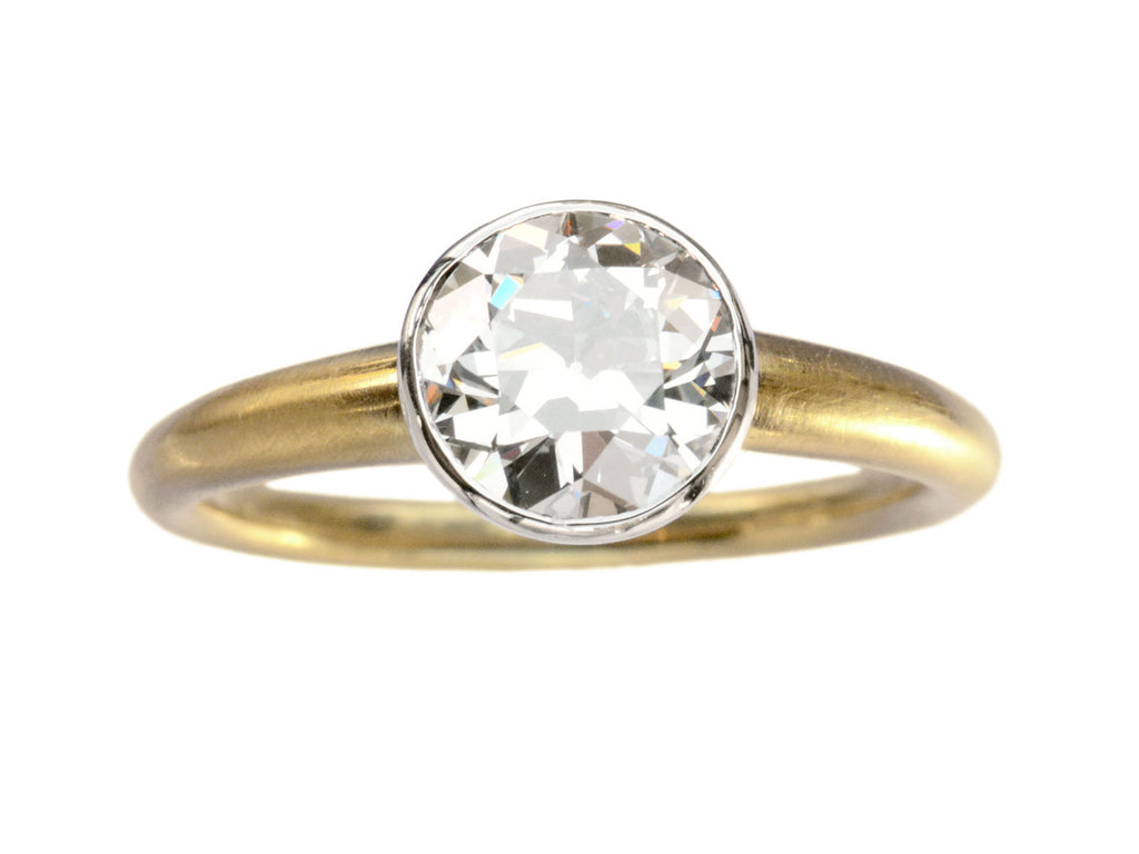 EB Modern engagement ring with 1.42ct round diamond set in platinum bezel with round 18K yellow gold shank. Shown on white background. 