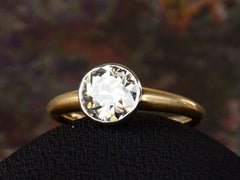 thumbnail of Angled view of EB Modern engagement ring with 1.42ct round diamond set in platinum bezel with round 18K yellow gold shank. Shown on dark background. 