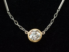 thumbnail of Detail of EB Modern necklace with round old cut diamond set in 22K yellow gold bezel on platinum chain. Shown on black background.