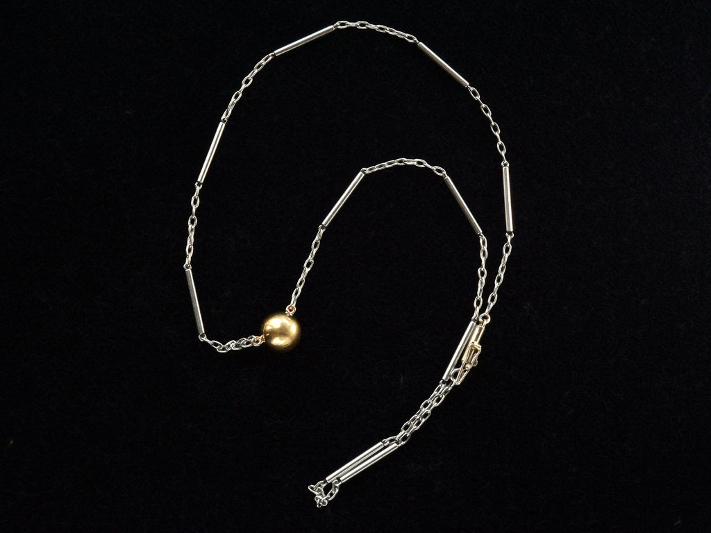 EB Modern necklace with domed 22K yellow gold bead (the reverse side of the diamond) on platinum chain. Shown on black background.
