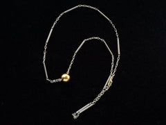 thumbnail of EB Modern necklace with domed 22K yellow gold bead (the reverse side of the diamond) on platinum chain. Shown on black background.