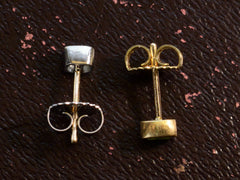 thumbnail of  Mismatched EB Modern Diamond and Green Sapphire Stud Earrings (side view shown on dark brown background)